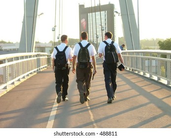 Three Young Mormons Walking On The Bridge