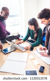 Three Young Multiethnic Business People Working Together Using Technological Devices - Trading, Business, Technology Concept