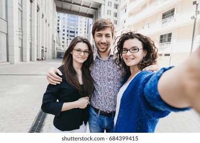 Three young people making selfie