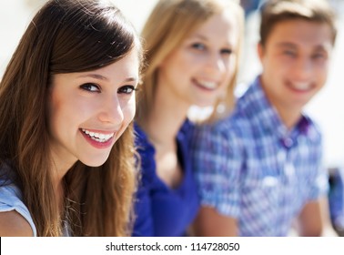 Three Young People Smiling