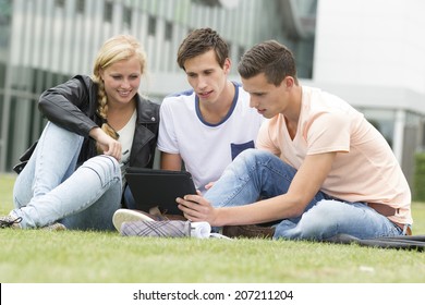 Three Young Student Watching Something On An Ipad