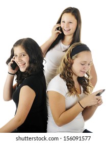 Three Young Teens Talking And Laughing On Their Communication Devices.  On A White Background.  Focus On Girl In Black.