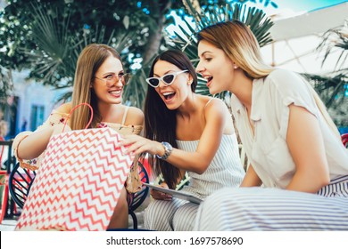 Three Young Women In A Cafe After A Shopping