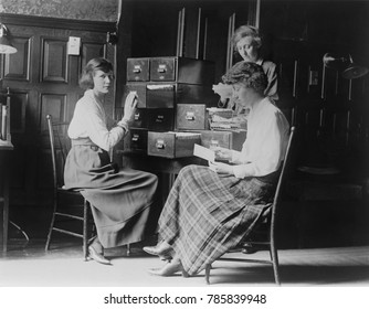 Three young women at the headquarters of the National Woman's Party in Washington, D.C., c. 1917-1921. They are working with index card files at the national headquarters