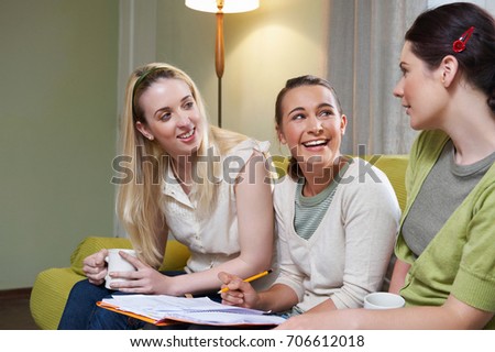 Three young women sitting on couch