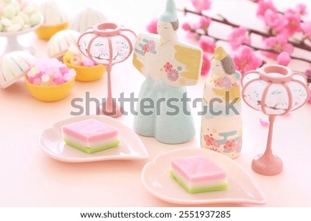 Three-colored kamaboko on pink plates  with beautiful peach blossoms for Hinamatsuri, japanese doll's festival　
