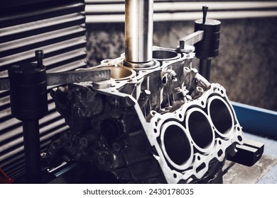 Three-cylinder engine repair on CNC machine, boring under the piston using machine with Computer Numerical Control. 