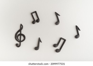 Three-dimensional black treble clef and music notes on white background. Violin key. Key of G. Music symbol