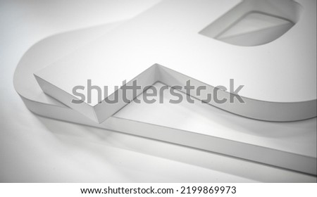 Three-dimensional letters made of plastic on a white background.Production of symbols in advertising production. Letters for advertising signage. Interior advertising.