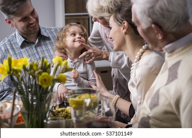 Three-generation Family Enjoying Festive Meal On The Easter Day