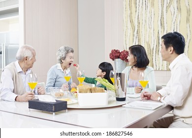 three-generation family having meal at home