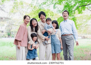 A three-generation family living happily with smiles on their faces - Powered by Shutterstock