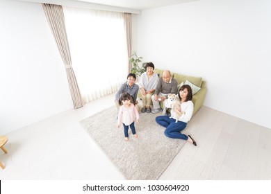 Three-generation Family Playing With Dog