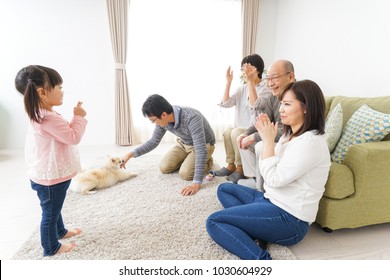 Three-generation Family Playing With Dog