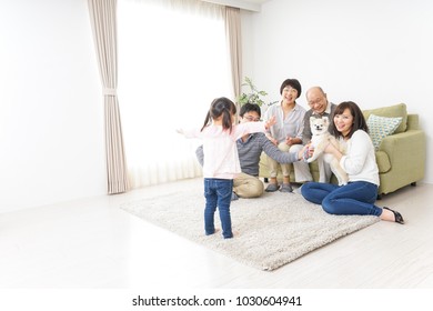 Three-generation Family Playing With Dog