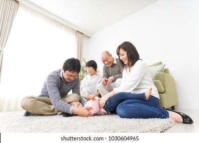 Three-generation Family Playing With Dog