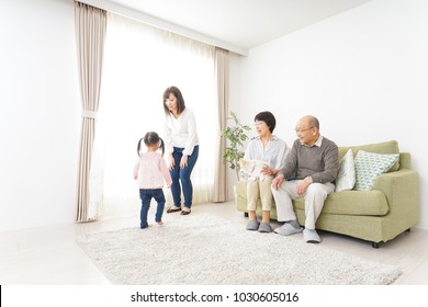 Three-generation Family Playing With Dog