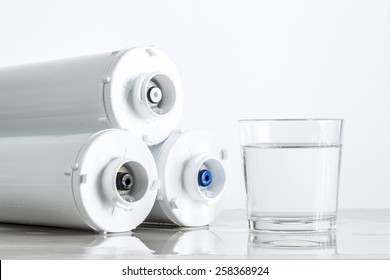 Three-level Cleaning Water Filters And Glass Of Water.