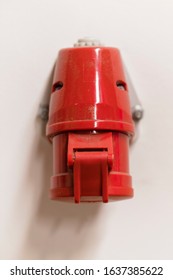 Three-phase socket on the wall red.
