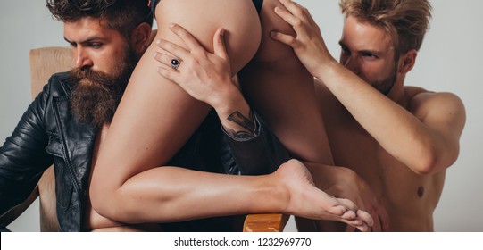 Threesome group sex game. Dominantning in the foreplay sexual game. Froup playing domination games. Sexy evening for young couple and sex protection. Safety sex concept