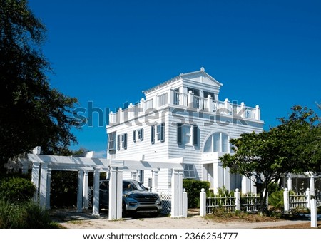 Three-story houses with white pergola and picket fence curb appeal along scenic 30A country road in Santa Rosa, South Walton, Destin, Florida Panhandle. Residential vacation homes clear blue sky Stock photo © 