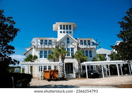 Three-story houses with white pergola and picket fence curb appeal along scenic 30A country road in Santa Rosa, South Walton, Destin, Florida Panhandle. Residential vacation homes clear blue sky Stock photo © 