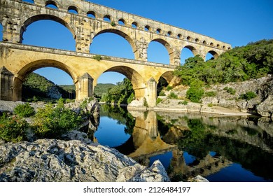 The three-tiered Pont du Gard aqueduct preserved from the time of the Roman Empire on the Gardon river near Avignon, Provence, France
