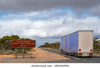 Three-trailer road train on "90 Mile Straight" on Eyre Highway between Balladonia and Caiguna on Nullarbor Plain of Western Australia