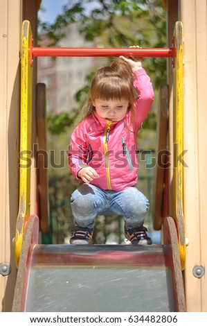 Similar – Happy little girl playing in a urban playground.