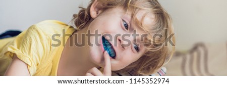 Three-year old boy shows myofunctional trainer to illuminate mouth breathing habit. Helps equalize the growing teeth and correct bite. Corrects the position of the tongue BANNER, long format