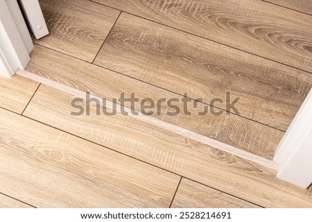 Threshold of the interior door. Thin flexible threshold on laminate