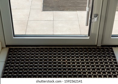 Threshold With A Rubber Foot Mat In The Front Glass Door Of The Office With Tiles On The Floor Close Up.