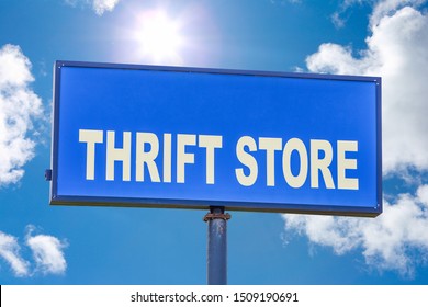 Thrift Store Sign Against A Blue Sky With Clouds And Sunshine 