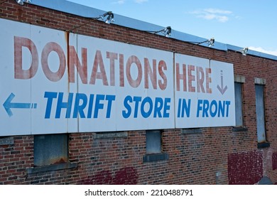 Thrift Store Sign On Old Brick Mill Building Exterior In Downtown Haverhill Massachusetts