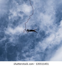 A Thrill Seeking Bungee Jumper Falling To The Ground.