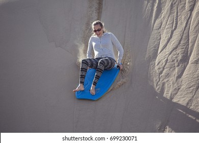Thrill Seeking Woman Playing In The Sand Dunes Outdoor Lifestyle
