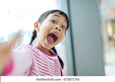 Thrilled Asian Girl Taking Selfie