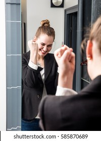 Thrilled Smart Young Beautiful Woman Laughing With Successful Joyful Body Language Standing In Front Of Her Home Mirror For Conviction And Dynamic Morning Routine