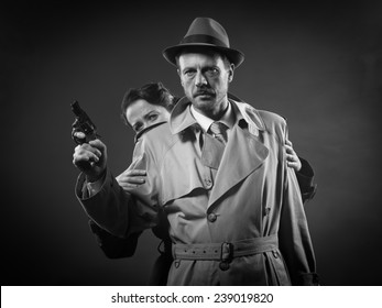 Thriller Film Noir Scene With Man Pointing A Gun And Woman Hiding Behind Him