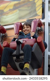 Thrilling Journey, An Exhilarated Youngster Embarks on a Dizzying Extravaganza Aboard Carnivals Whirlwind Coaster