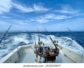 A thrilling scene of marlin fishing off the coast of Mindelo, Cape Verde. The view from the back of a fishing boat captures the open ocean, with fishing rods poised and ready for action. - Powered by Shutterstock