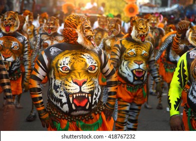 THRISSUR, INDIA - SEPT 19: Body painted tiger dance artists perform at Swaraj round on September 19, 2013 in Thrissur, Kerala,India. Tiger dance is a traditional dance performed during Onam festival.