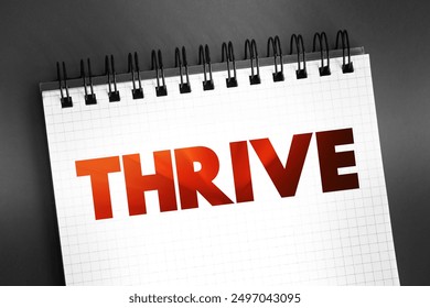 Thrive text quote on notepad, concept background