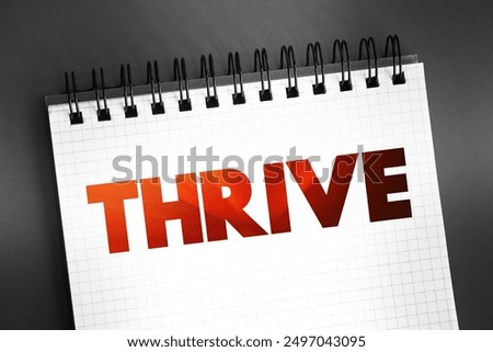Thrive text quote on notepad, concept background