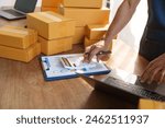 Thriving small businesses, often run by male freelancers, entrepreneurs, leverage e-commerce and logistics for online orders. home offices, manage packaging, shipping, client relations using laptops.