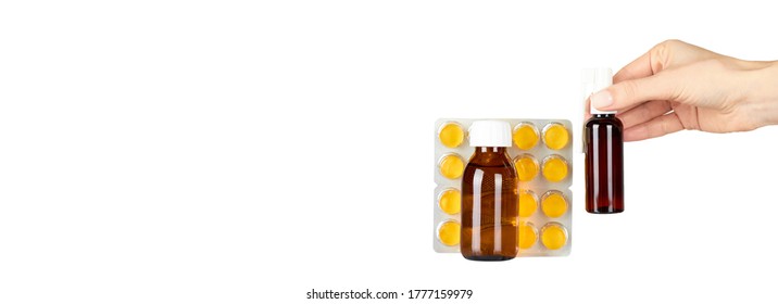 Throat ache pills in bister, spray and syrup with hand, isolated on white background. Copy space template, banner. - Shutterstock ID 1777159979