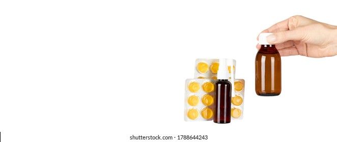 Throat ache pills in bister, spray and syrup with hand, isolated on white background. Copy space template, banner. - Shutterstock ID 1788644243