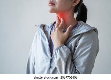 Throat pain. Young woman touching painful neck,Sore throat in flu season.  - Shutterstock ID 2069702606