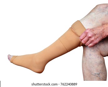 Thrombosis stockings on a leg of old woman isolated on white background.