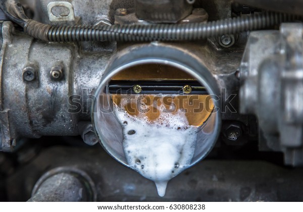 throttle valve is controlled with a throttle pedal or
lever via a direct mechanical linkage.
A fragment of the engine
car that old and shabby. hand of mechanic is to clean your car's
engine safely 